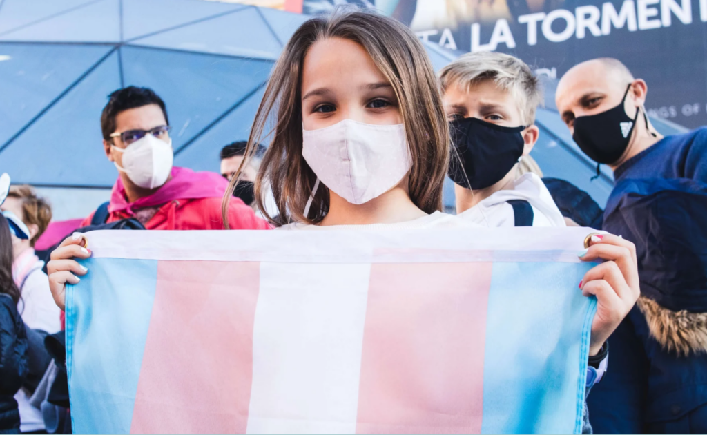 Protester holds Transgender Pride flag