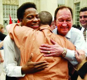 Clients Tyrone Garner and John Lawrence get a hug from a Houston resident after a rally at Houston City Hall celebrating the U.S. Supreme Court decision that the Texas sodomy law was unconstitutional.