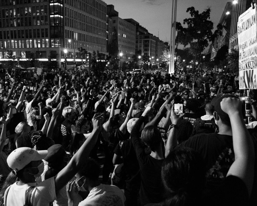 Black and white image of protesters protesting racial injustice
