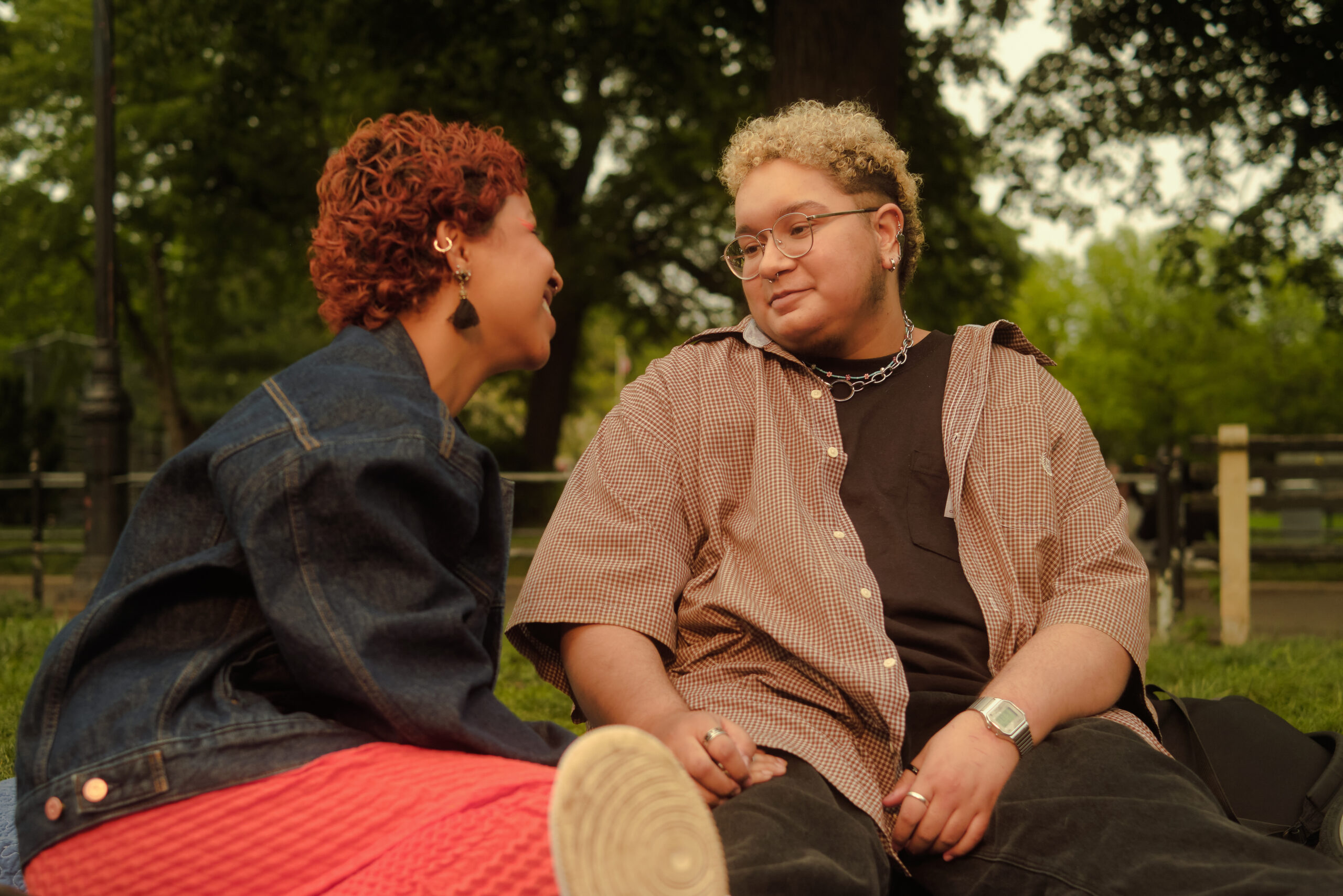 A trans couple sharing a moment in the park